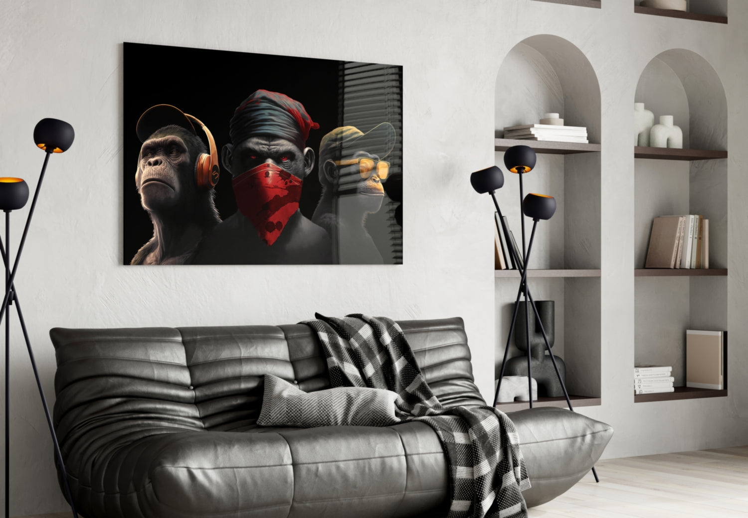 Modern living room with black leather sofa displaying three stylized monkeys artwork on wall above, each wearing headphones, bandana, and earphones in black and gold tones.