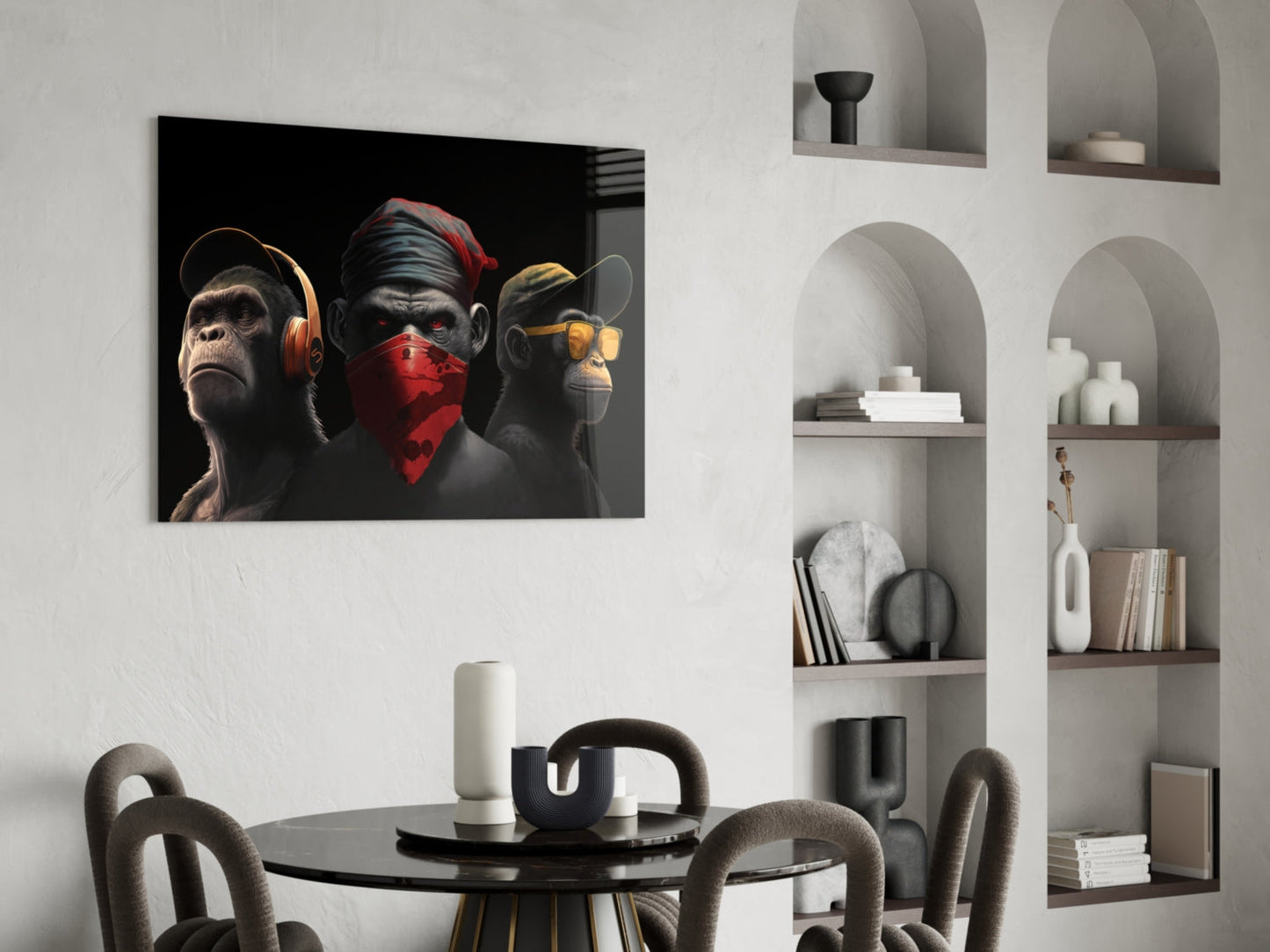 Three stylized monkeys wearing headphones, red bandana, and sunglasses displayed above a dining table in a modern interior setting.
