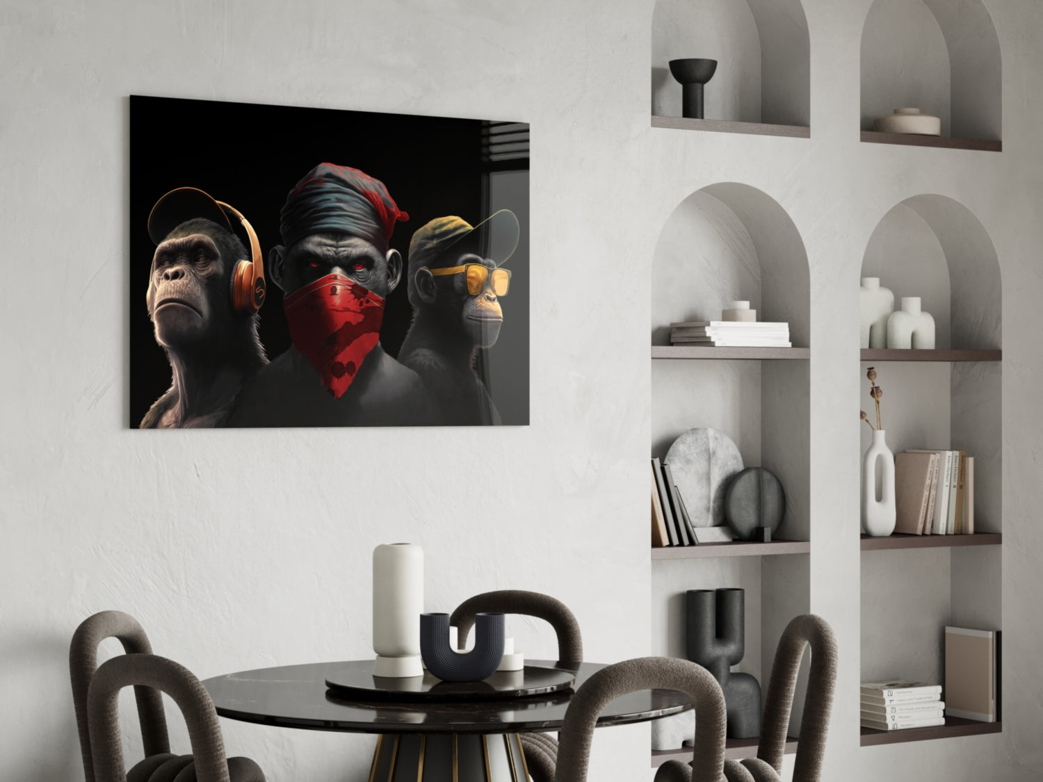 Three stylized monkeys wearing headphones, red bandana, and sunglasses displayed above a dining table in a modern interior setting.
