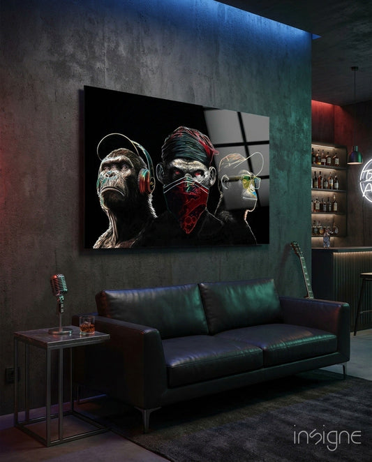 Modern living room with black leather sofa displaying large glass wall art of three stylized figures wearing headphones and red bandana against dark background.
