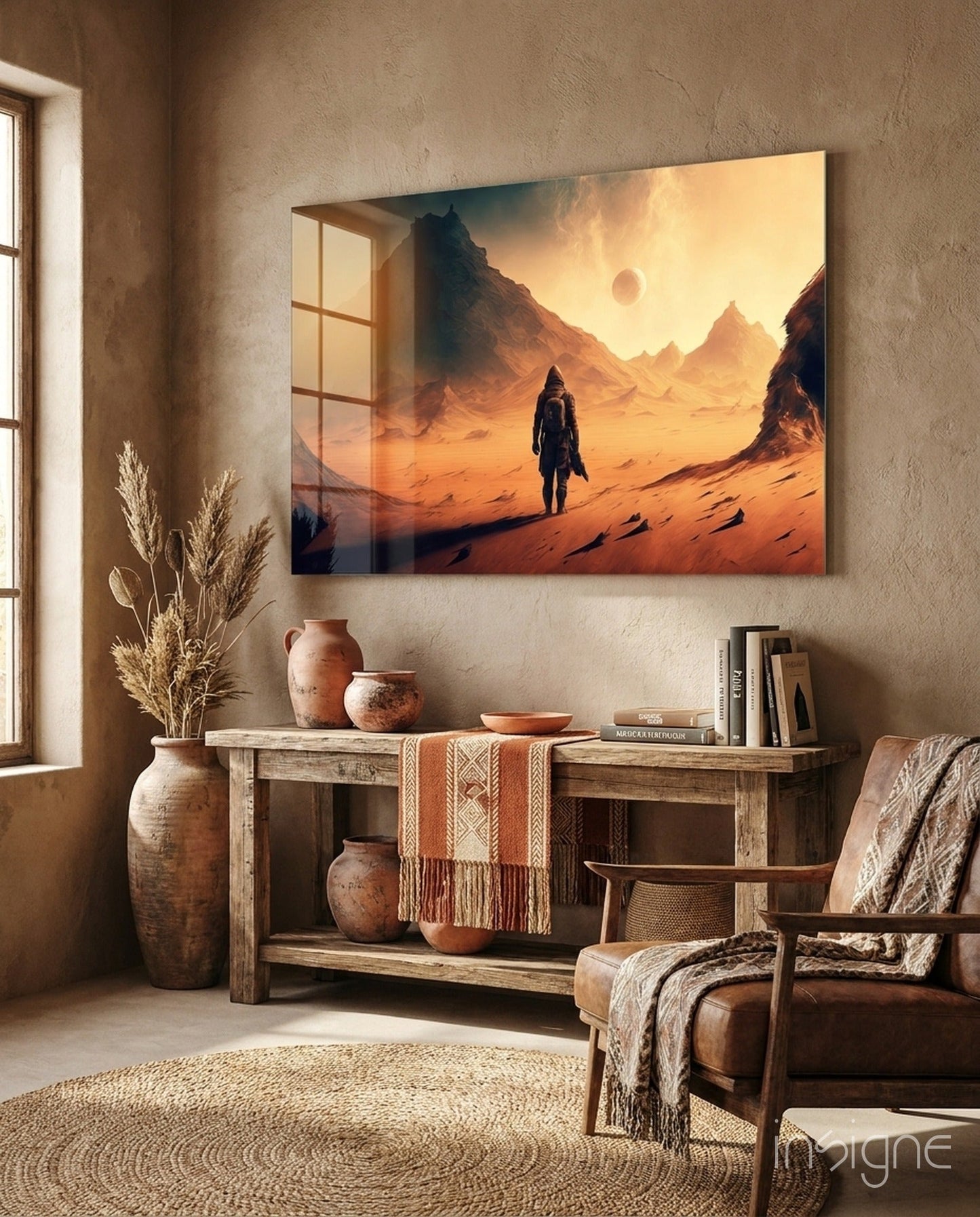 Glass wall art depicting a lone astronaut standing on an orange desert planet with mountains and a sunset sky, displayed above a wooden console in a warm, earth-toned room.