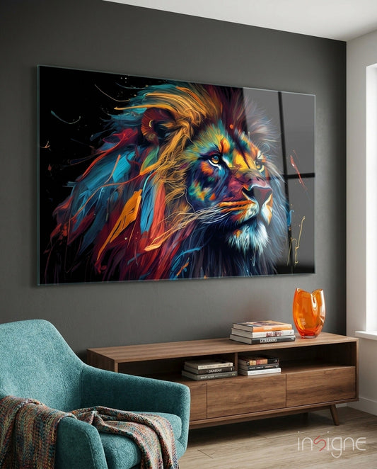 Colorful abstract lion portrait displayed on dark gray wall above wooden media console with teal armchair visible in foreground.