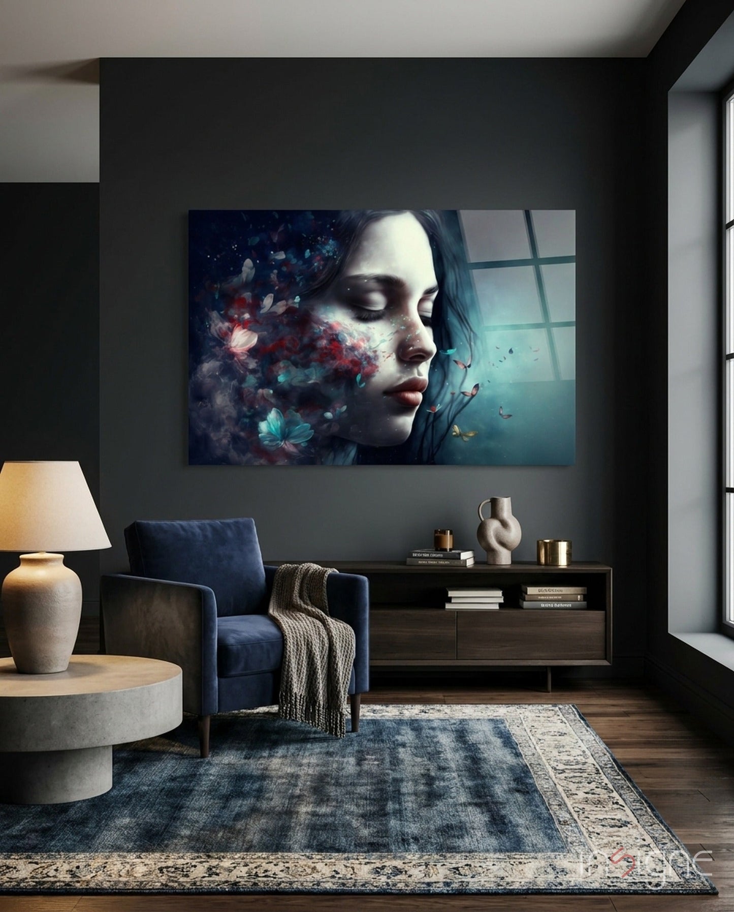 Modern living room with dark walls displaying glass wall art of a woman's profile with blue and red floral dissolve effect and window view.