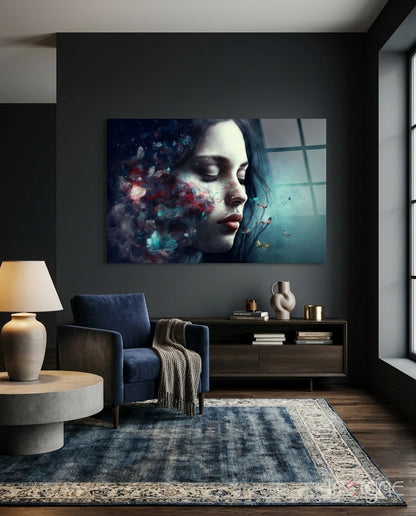 Modern living room with dark walls displaying glass wall art of a woman's profile with blue and red floral dissolve effect and window view.