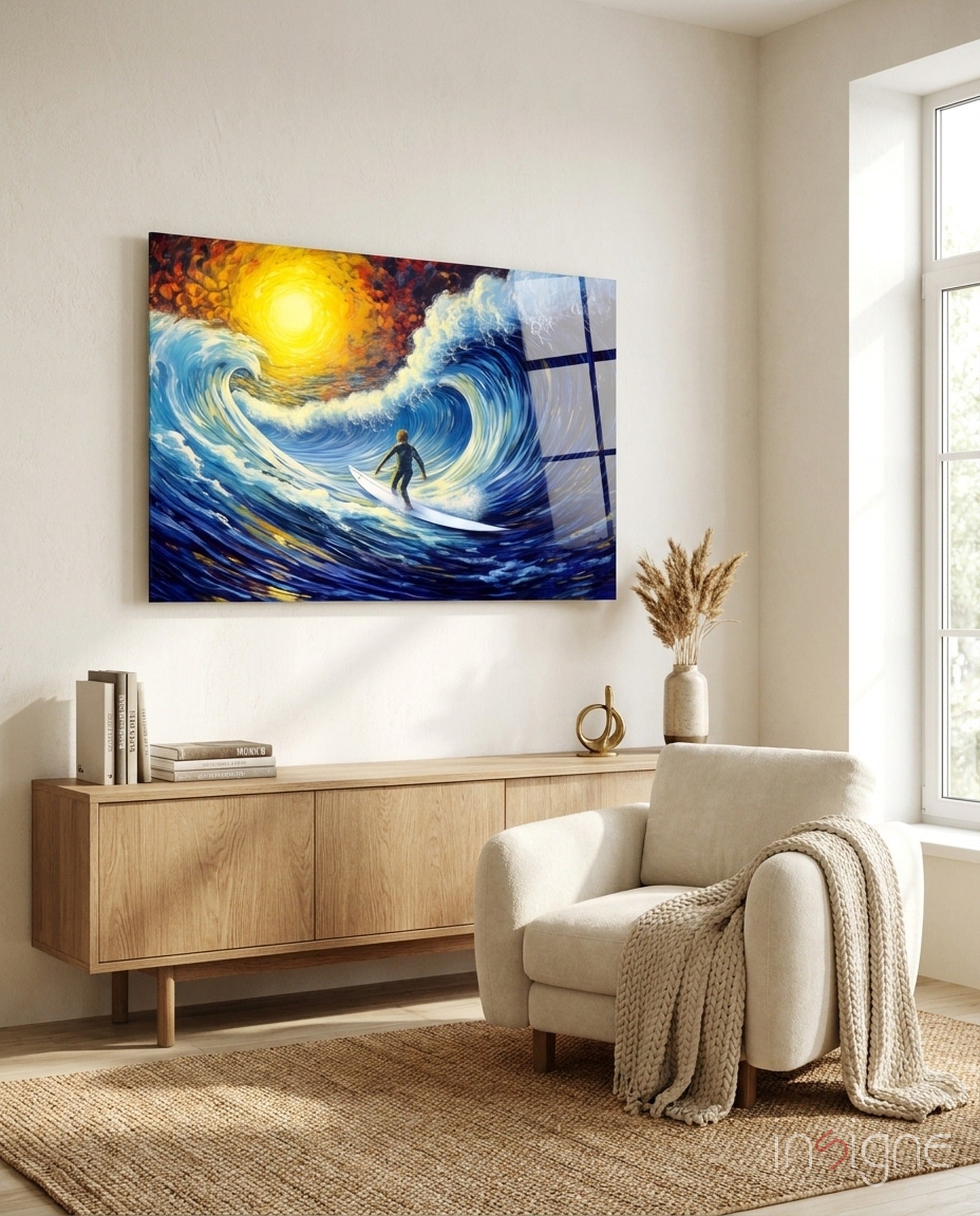 Surfing-themed glass wall art depicting a surfer on stylized blue waves under a golden sun, displayed above a wooden sideboard in a minimalist living room.