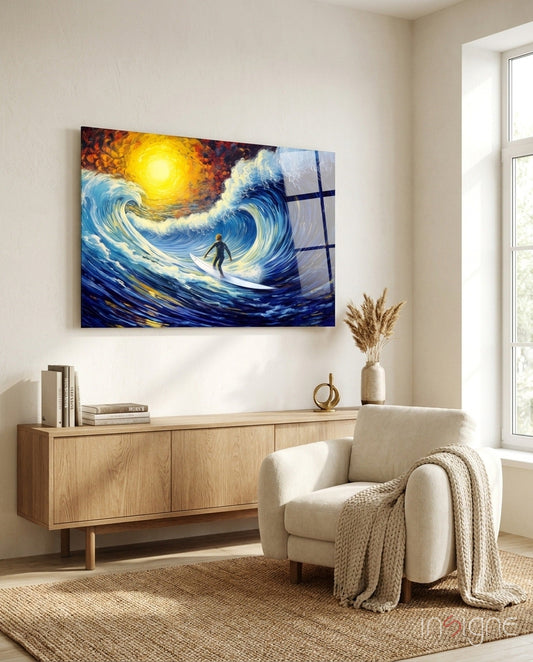 Surfing-themed glass wall art depicting a surfer on stylized blue waves under a golden sun, displayed above a wooden sideboard in a minimalist living room.