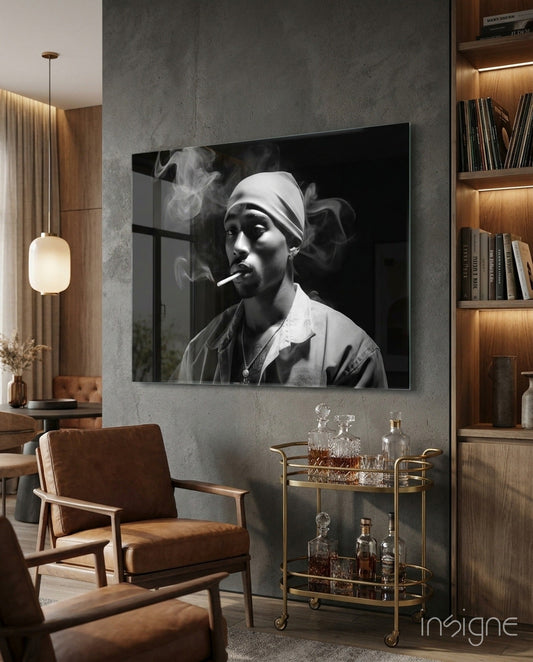 Black and white glass wall art depicting a man wearing a gray bandana and smoking a cigarette, displayed in a modern living room above a bar cart.