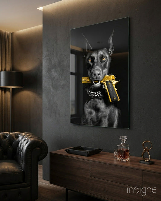 Black doberman with gold pistol and studded collar displayed on dark wall above wooden desk in luxury room setting.
