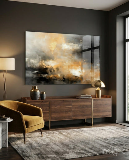 Abstract glass wall art with layered tan, gold, and grey tones mounted above wooden credenza in modern living room setting.
