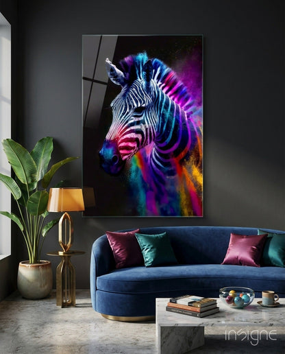 Colorful zebra glass wall art displayed above blue sofa in modern living room with plant and lamp.