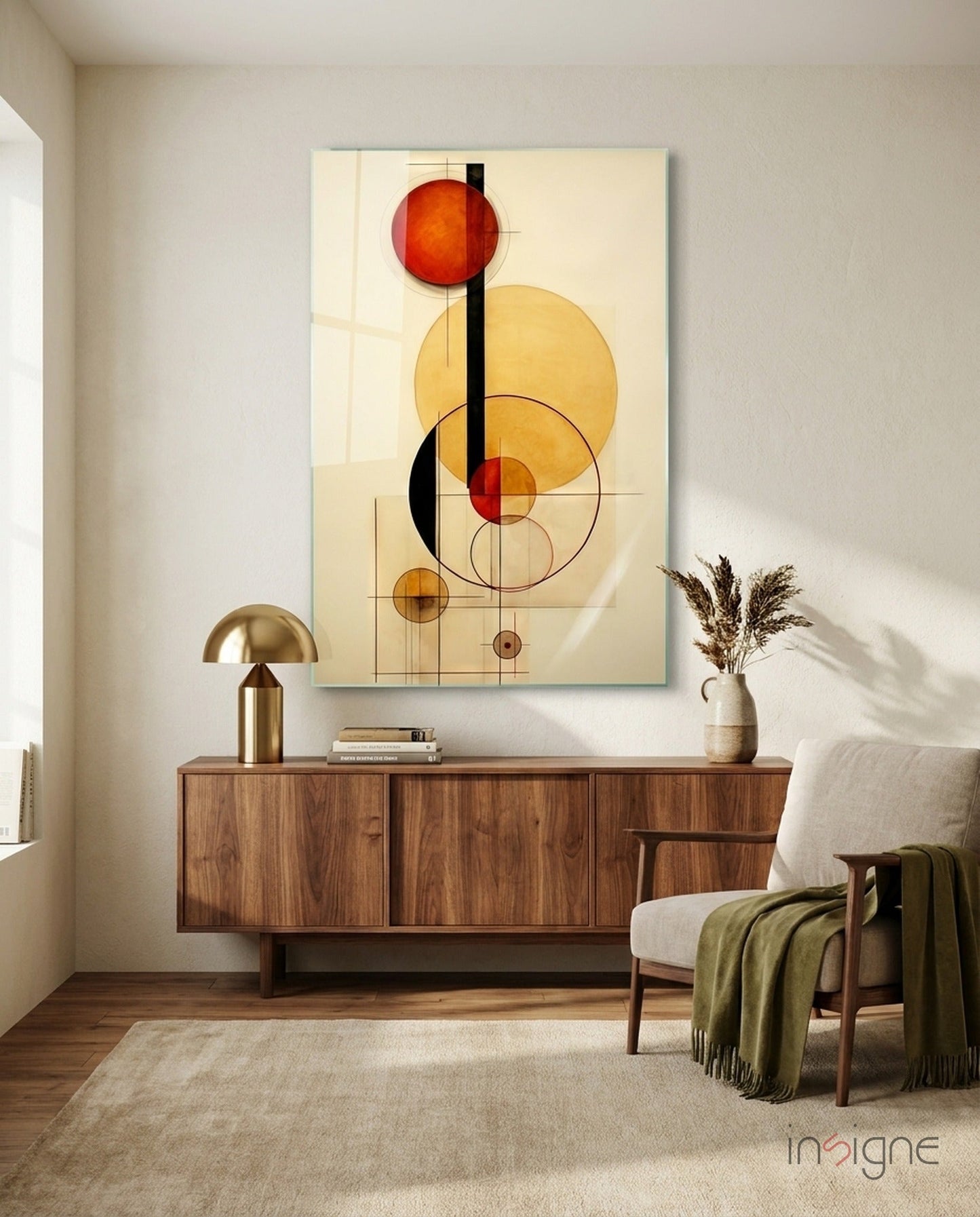 Abstract geometric glass wall art featuring overlapping circles in red, yellow, and black on cream background, displayed above wooden sideboard in modern living room.