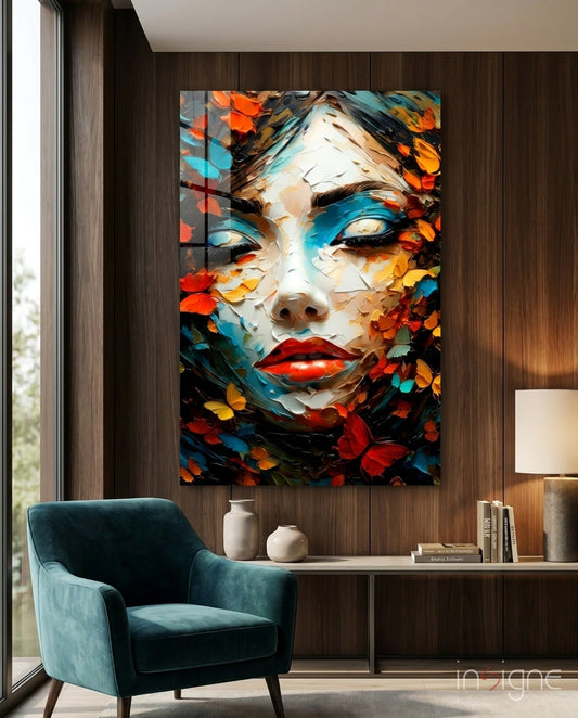 Colorful abstract portrait with red lips and butterflies displayed on dark wood wall above teal armchair in modern interior setting.
