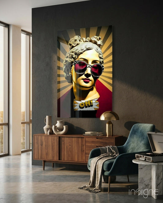 Golden classical bust with sunburst rays and "OH!" text on dark charcoal wall above wooden credenza in modern interior.