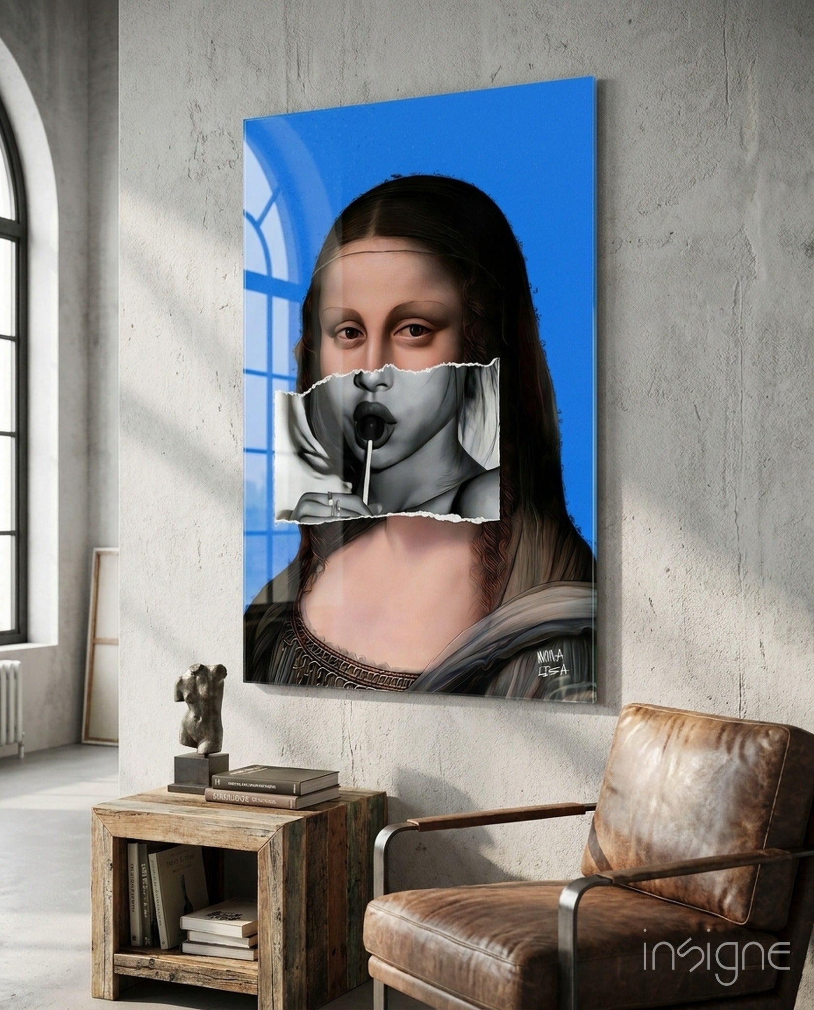 Contemporary Mona Lisa glass wall art displayed in modern loft interior with leather chair, blue background, and surreal mouth overlay detail.