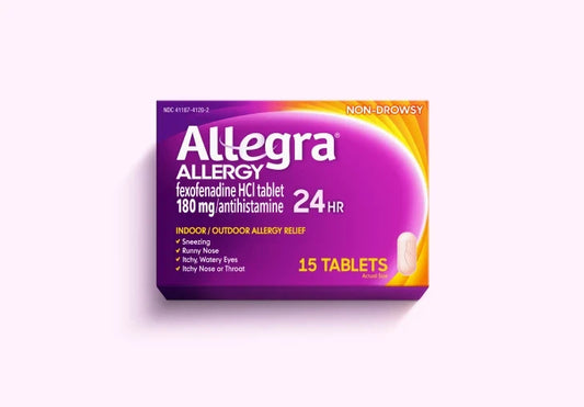 Purple and yellow Allegra Allergy 24HR medication box displaying 15 tablets, photographed at an angle against a light background.