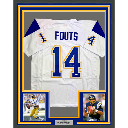 Framed white San Diego Chargers jersey number 14 with "FOUTS" nameplate, flanked by two photographs of the player, set against blue and gold matting.