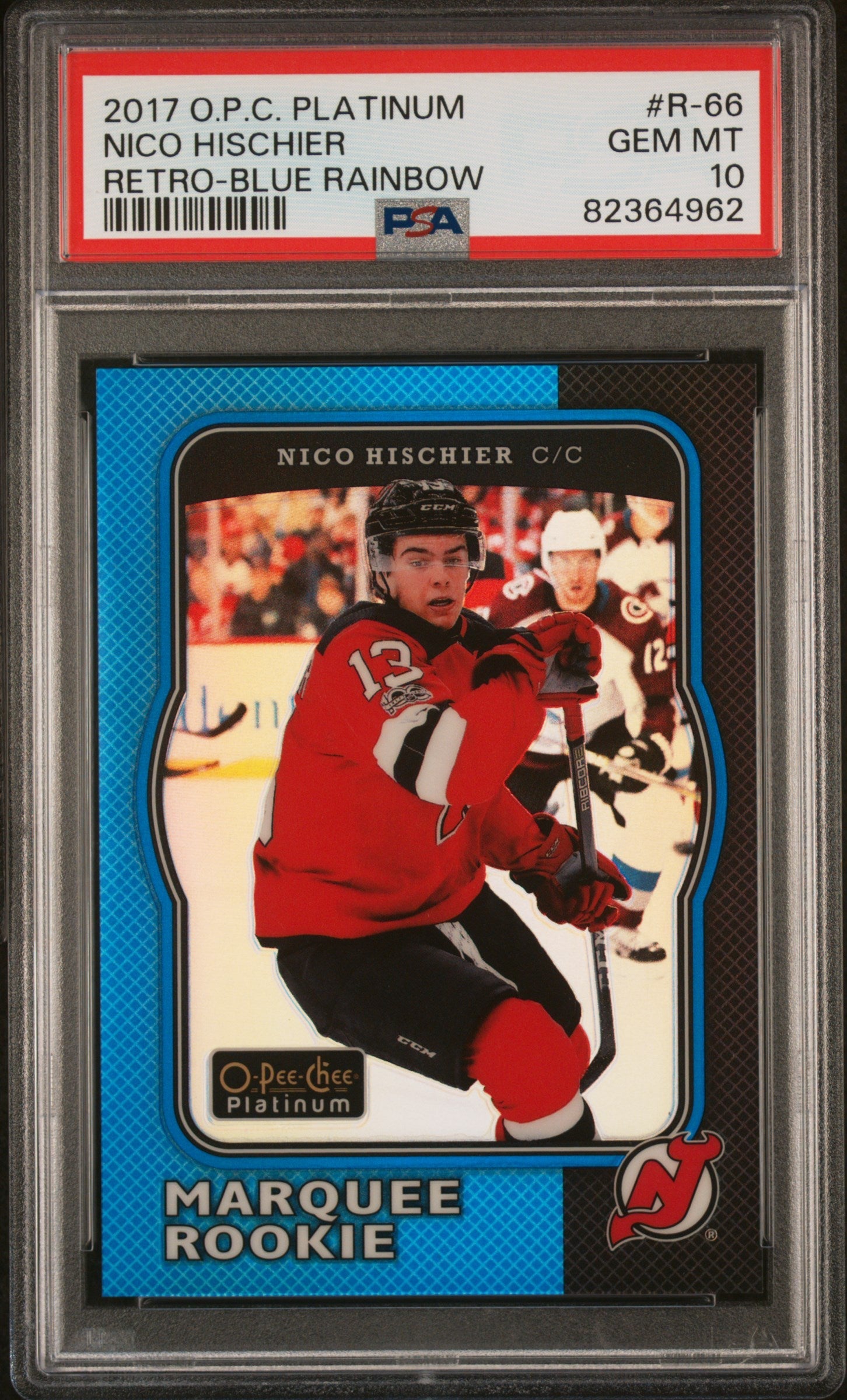 PSA-graded trading card in plastic case showing Nico Hischier in red New Jersey Devils jersey, blue-bordered card front with "Marquee Rookie" text visible.