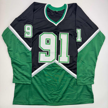Black and green hockey jersey with white trim displaying number 91 laid flat on white background, front view.