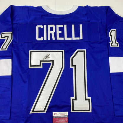 Back view of blue hockey jersey with white "CIRELLI" nameplate and large "71" numbers, signed in black marker, with JSA authentication label visible.