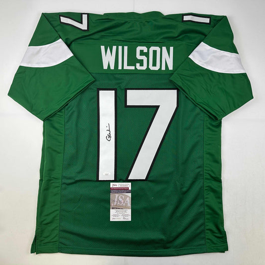 Green New York Jets football jersey number 17 with "WILSON" nameplate, displayed flat with JSA authentication certificate visible.