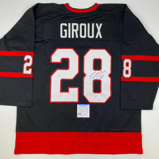 Back view of signed black hockey jersey with red and white horizontal stripes, number 28, and "GIROUX" nameplate with PSA authentication certificate.