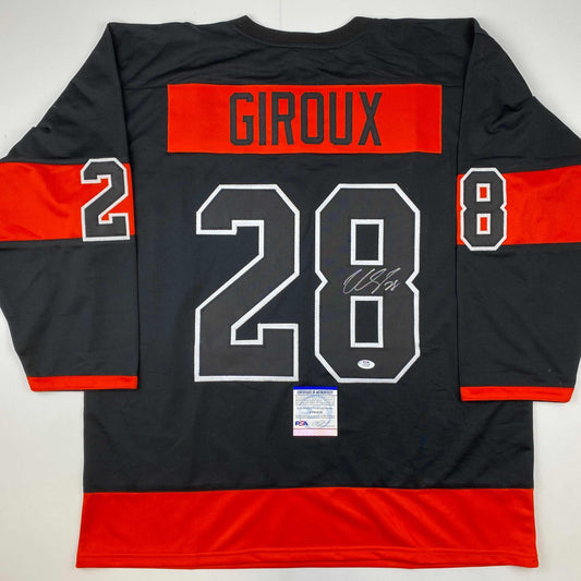 Back view of black and red hockey jersey with "GIROUX" and number "28" in white outlined numerals, signed in silver marker, with PSA/DNA authentication certificate at bottom.