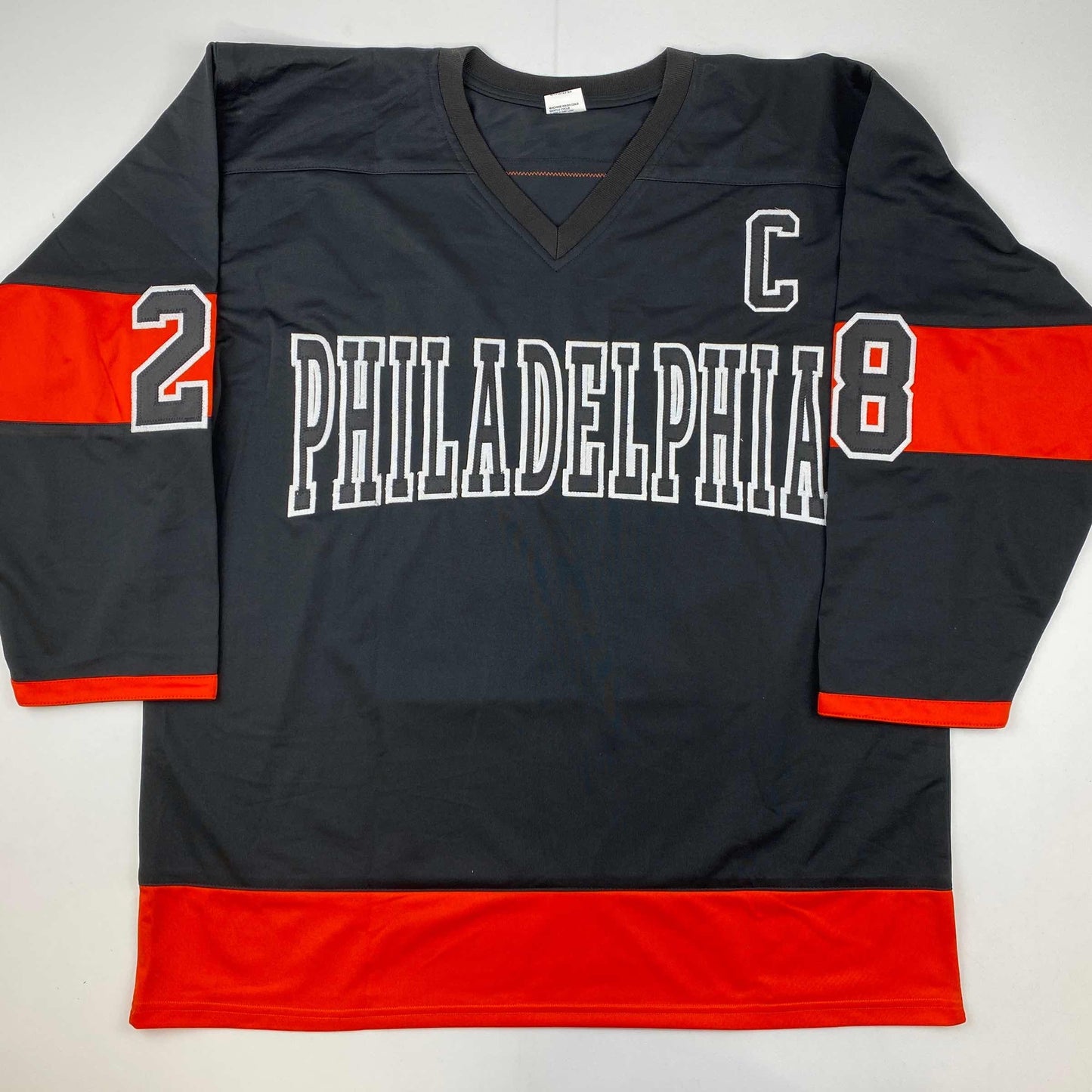 Black and red Philadelphia hockey jersey with white "PHILADELPHIA" text and numbers 2 and 8, displayed flat against white background.