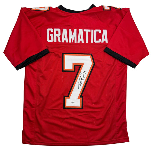 Red football jersey with "GRAMATICA" across chest, number 7 with signature, black and orange trim, flat lay front view.