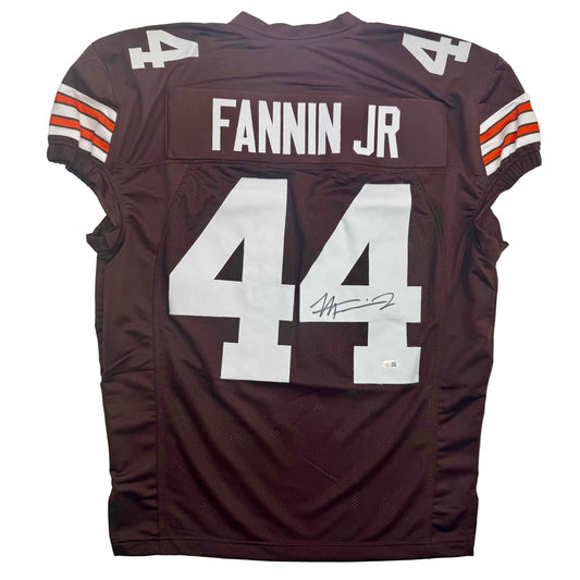 Back view of maroon football jersey number 44 with "FANNIN JR" nameplate and autographed signature on white number.