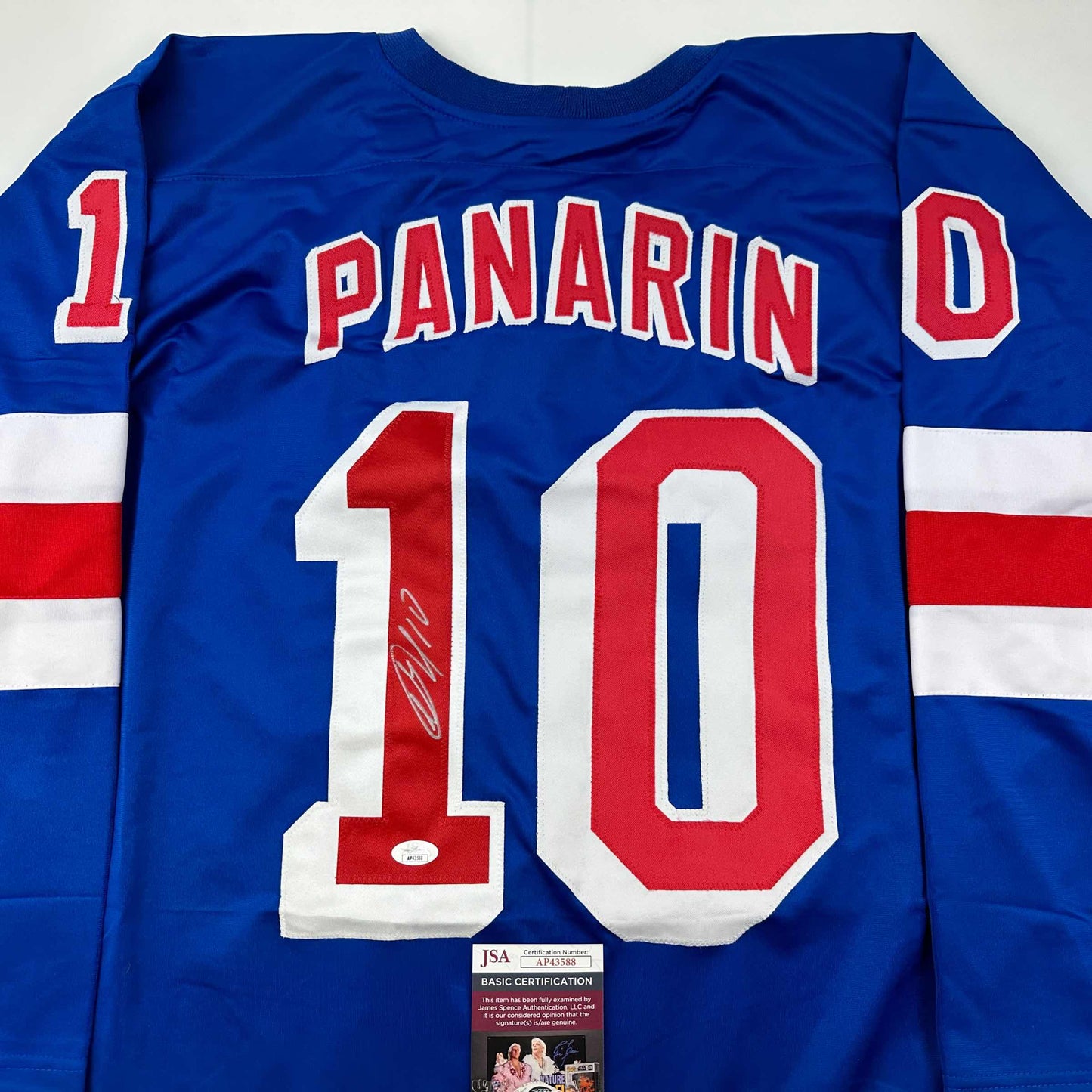 Blue hockey jersey displaying "PANARIN" and number 10 with autograph and JSA certification sticker.