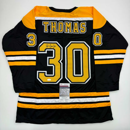 Black and gold Boston Bruins hockey jersey number 30 with THOMAS nameplate, displayed flat with JSA authentication certificate visible.