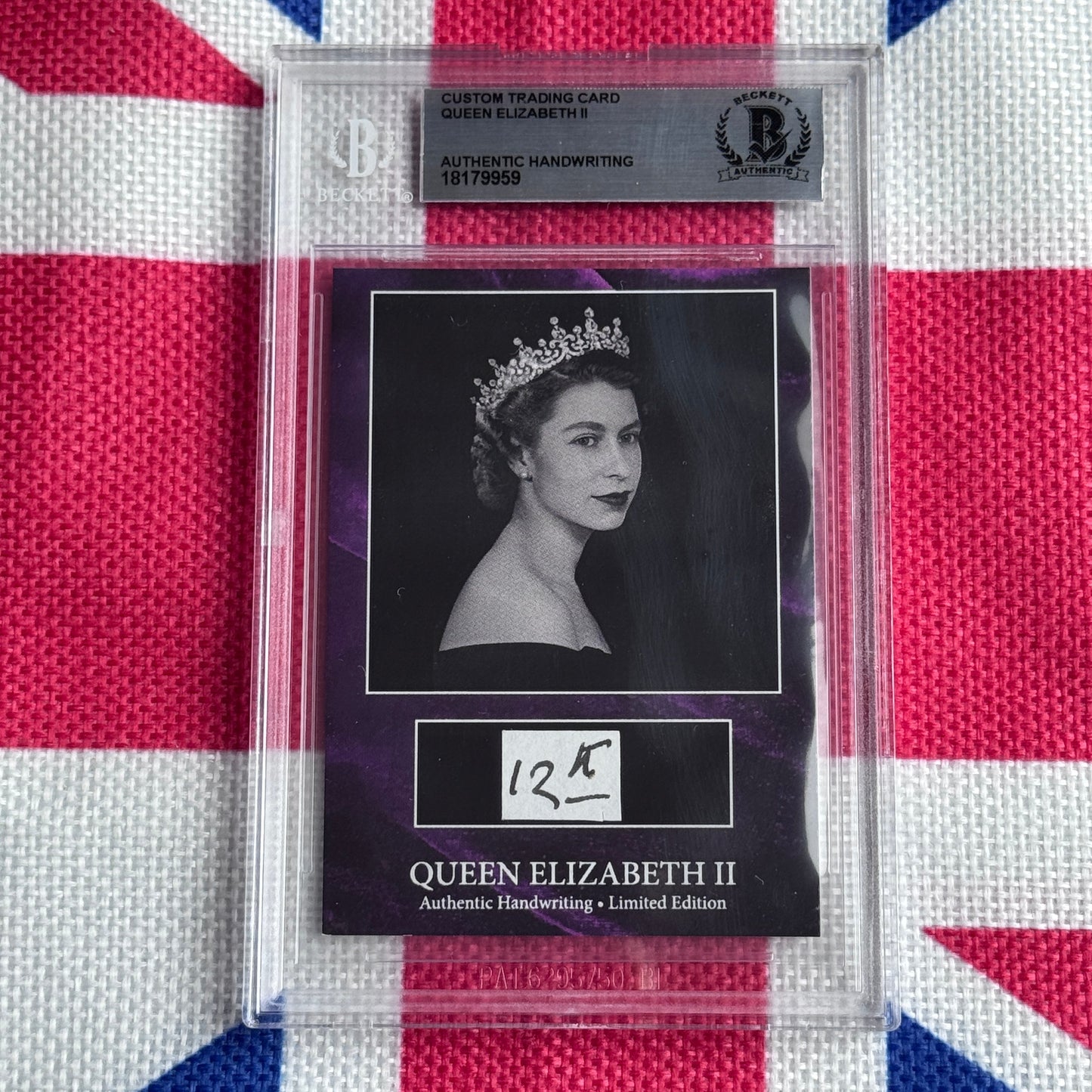 Beckett-authenticated Queen Elizabeth II handwriting trading card in clear case displayed against Union Jack background, showing black-and-white portrait photograph with tiara and handwritten signature.