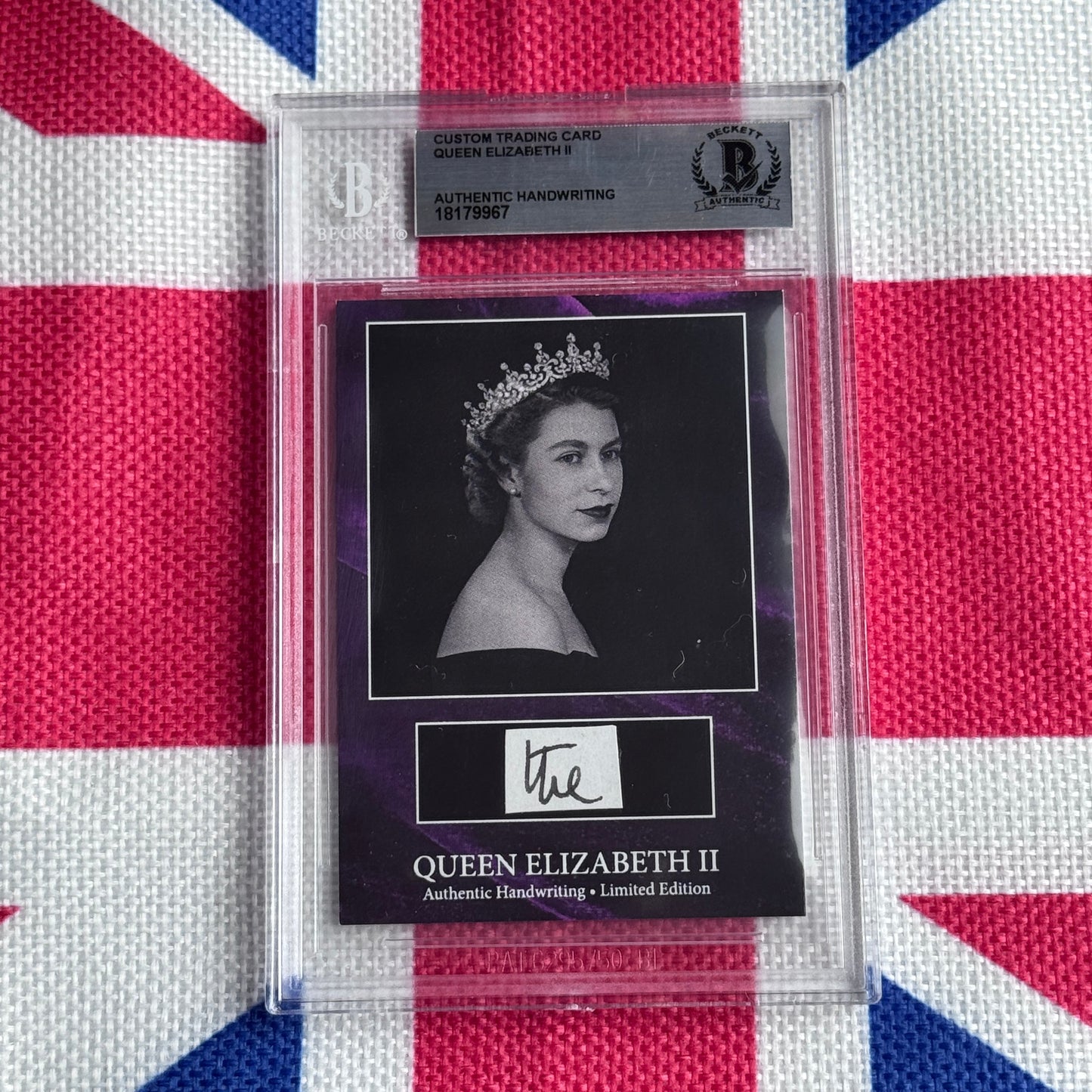 Authenticated trading card featuring Queen Elizabeth II portrait with tiara and handwritten signature on black mount, displayed against Union Jack background.