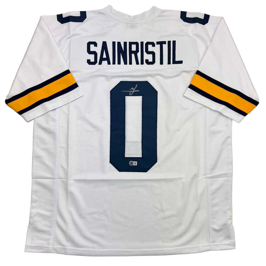 White college football jersey with "SAINRISTIL" name and number "0" on back, navy and gold sleeve stripes, displayed flat.
