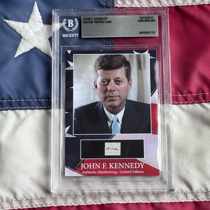 John F. Kennedy trading card by Beckett featuring his photograph, signature sample, and American flag background, displayed in protective case.