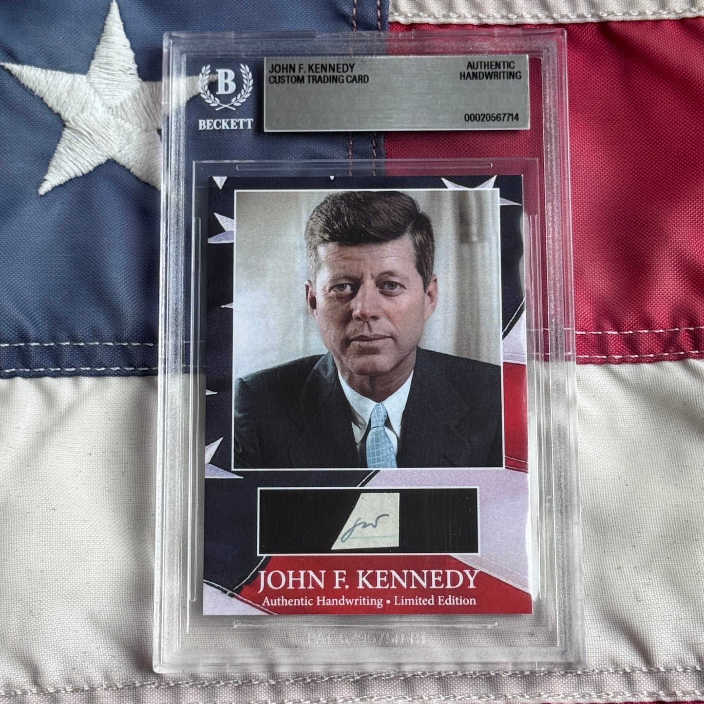 Beckett-authenticated trading card featuring John F. Kennedy portrait photograph with signature and American flag background.