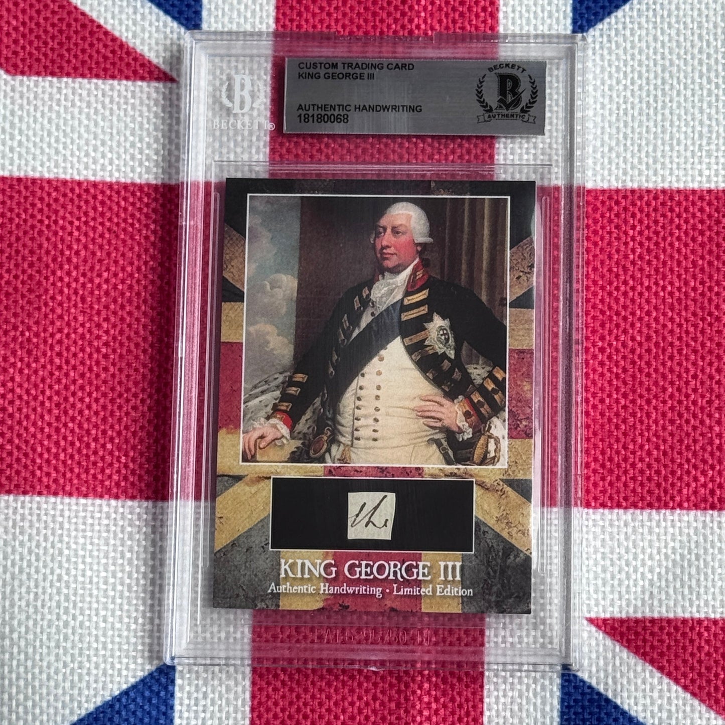Custom trading card featuring King George III portrait in military dress with authenticated handwriting sample, displayed in clear protective case against Union Jack background.