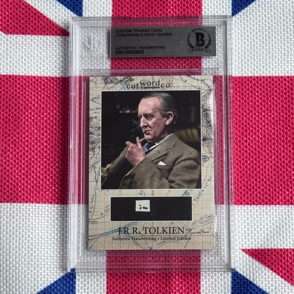Graded trading card with photograph of J.R.R. Tolkien in brown jacket against dark background, mounted on beige map-patterned card stock with authenticity label above.