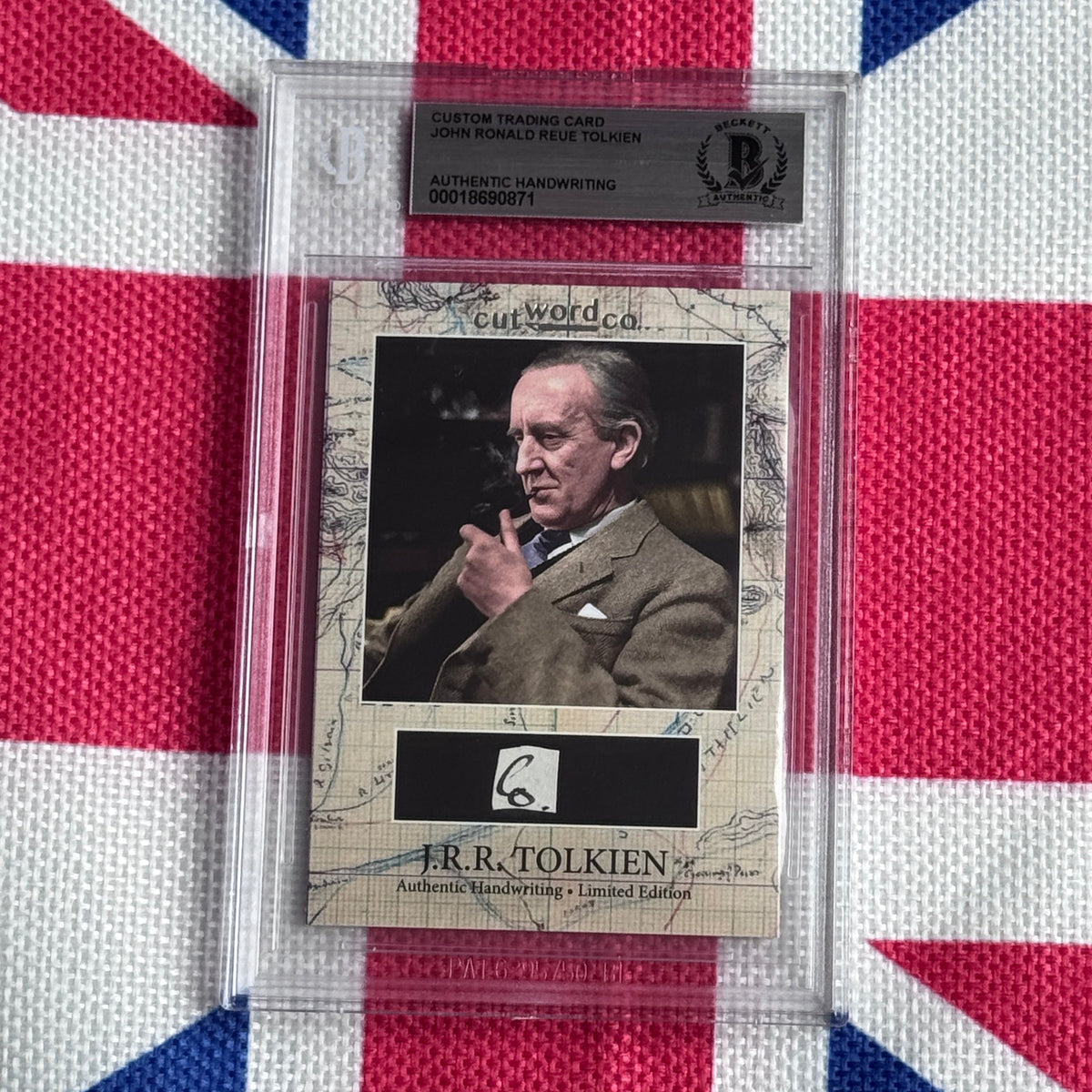 Beckett-graded custom trading card featuring J.R.R. Tolkien photograph with authentic handwriting signature and map-patterned border, displayed against Union Jack fabric background.