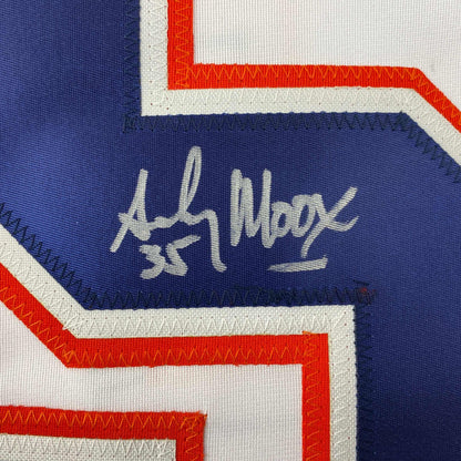 Close-up of handwritten signature on navy blue panel of white, red, and blue striped hockey jersey.
