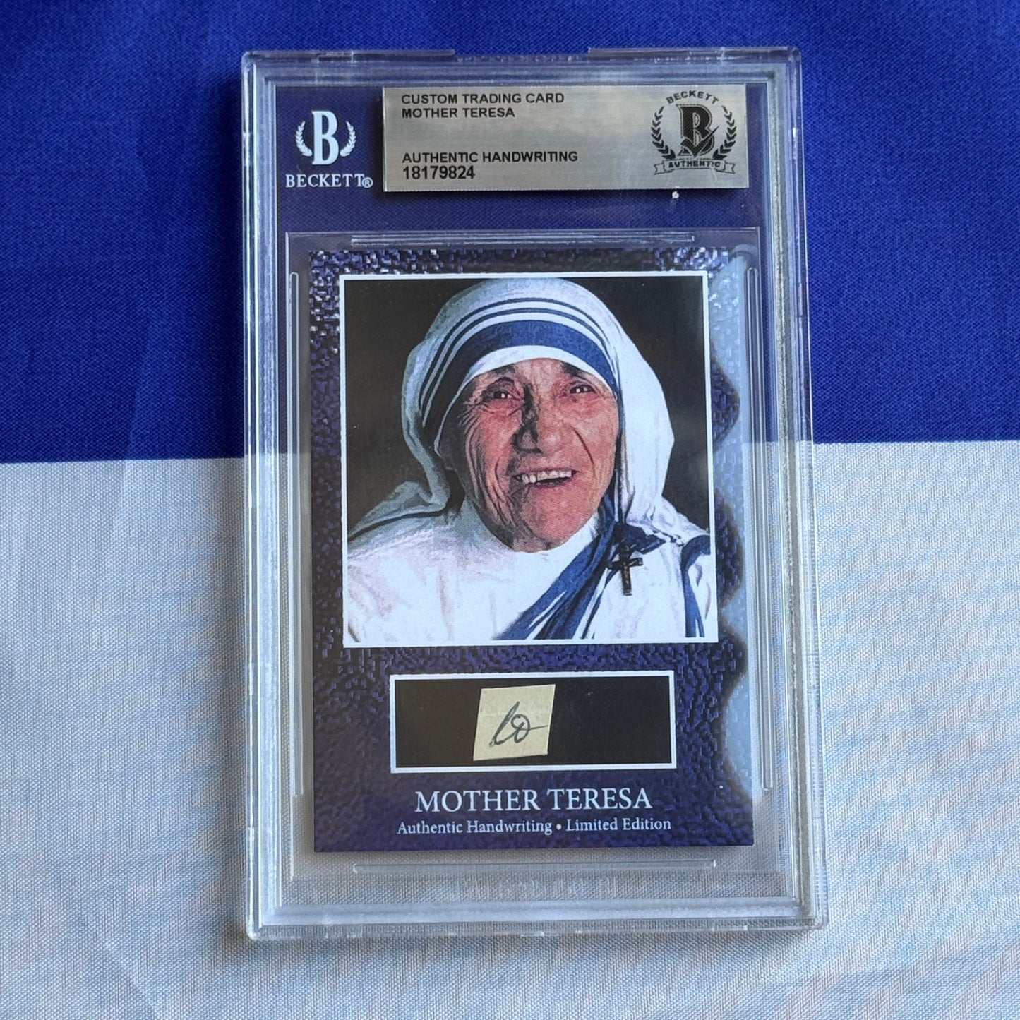 Beckett-graded custom trading card featuring Mother Teresa portrait photograph with authentic handwritten signature and blue Beckett authentication label against blue background.