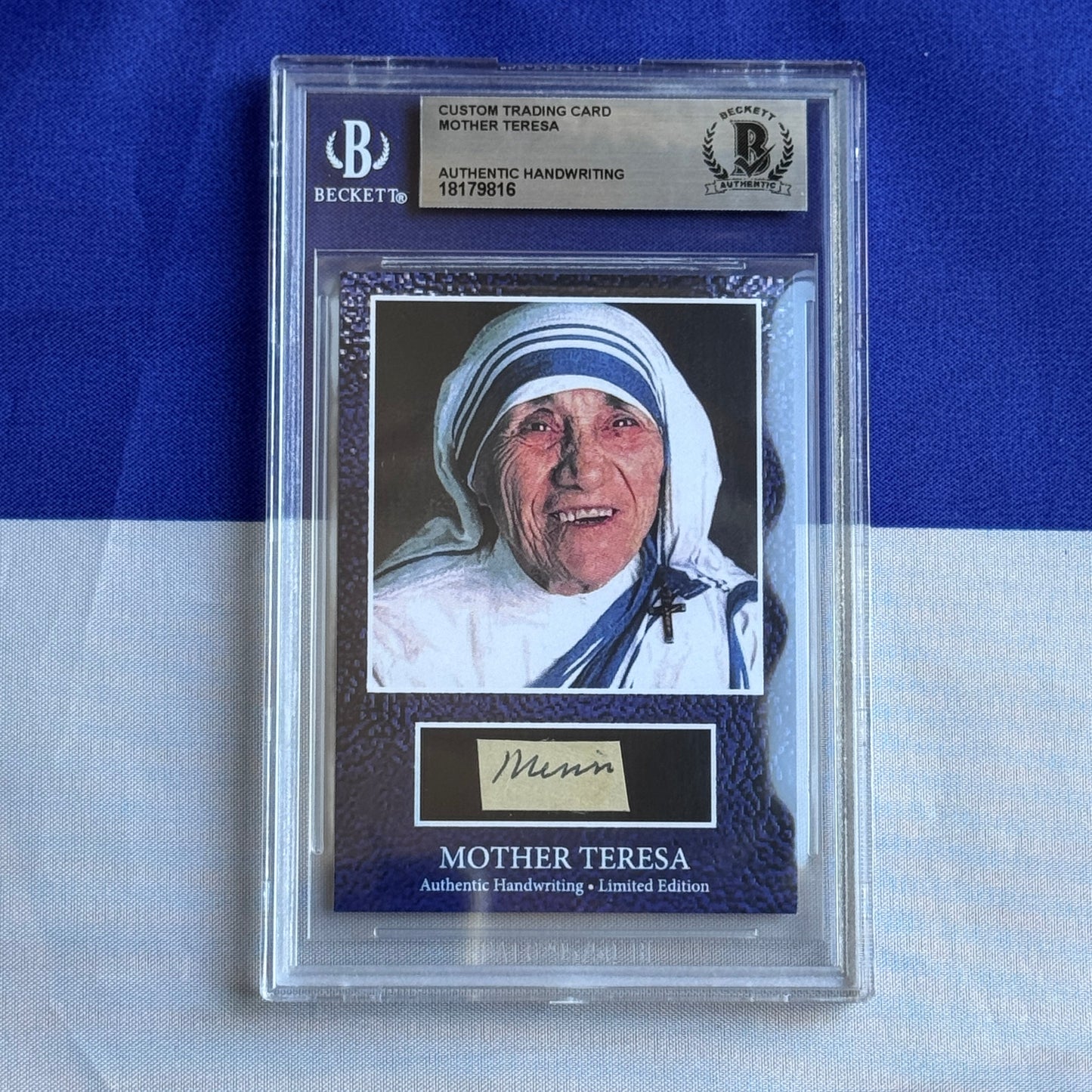 Beckett-graded custom trading card featuring Mother Teresa photograph with blue headwrap and handwritten signature on cream-colored nameplate.
