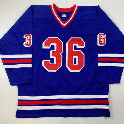 Blue hockey jersey with red number 36 and striped sleeves, displayed flat against white background.