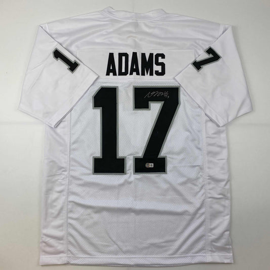 Back view of white mesh football jersey displaying "ADAMS" and number "17" with autographed signature on the number.