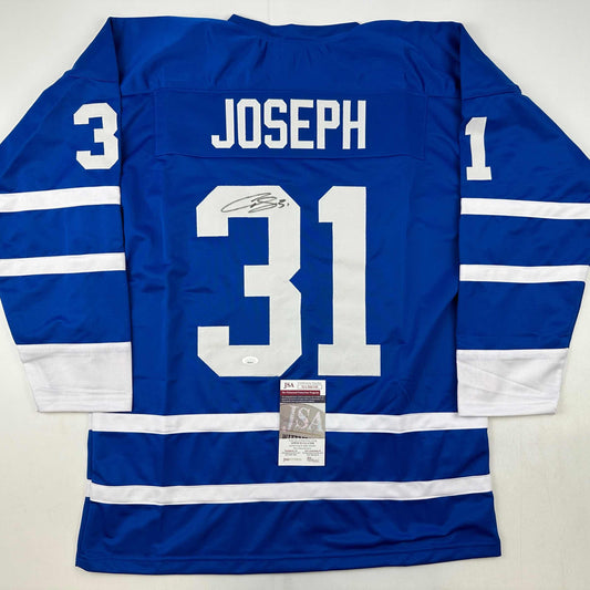 Blue Toronto Maple Leafs hockey jersey number 31 with "JOSEPH" nameplate and signature, displayed flat with JSA authentication certificate visible.