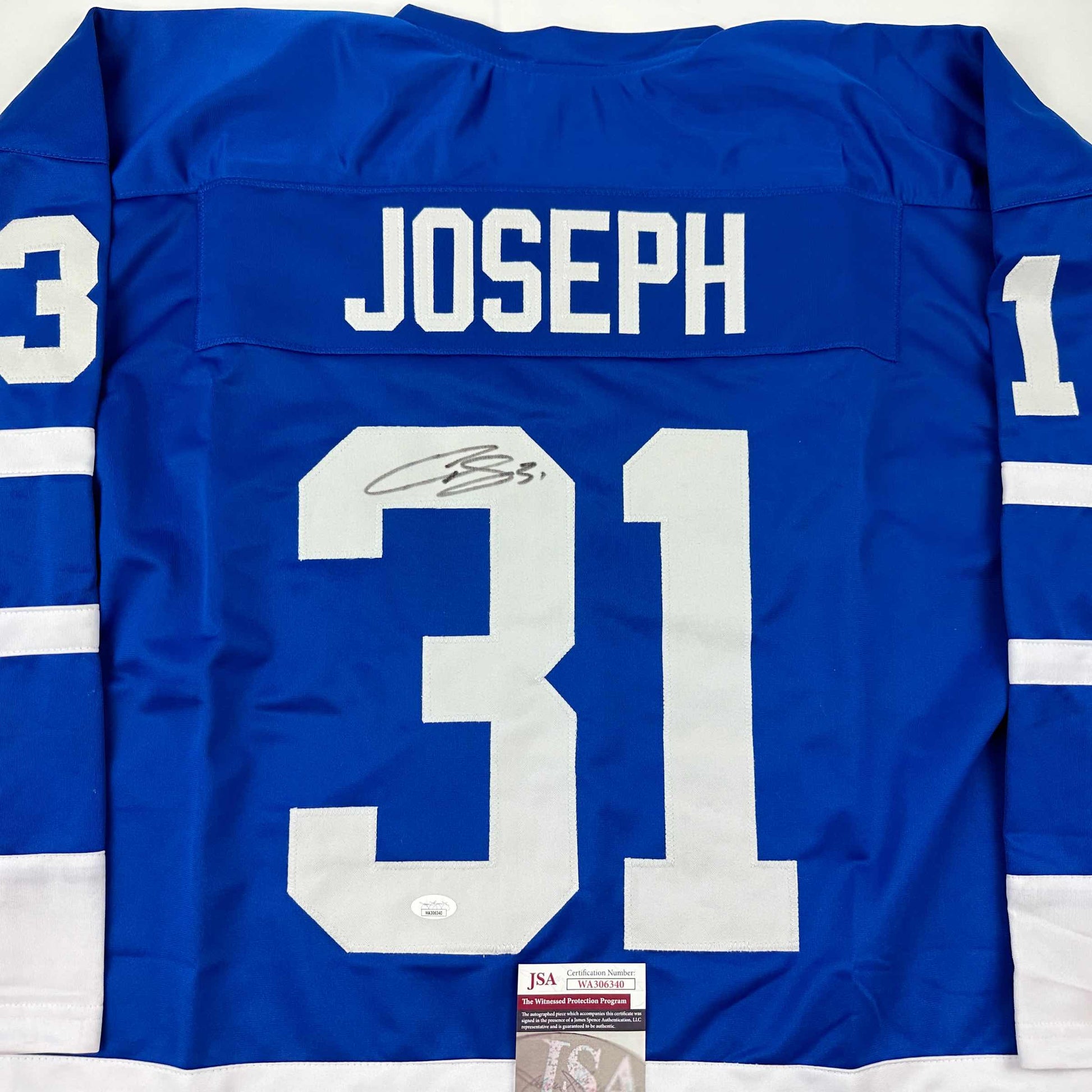 Blue Toronto Maple Leafs hockey jersey displaying "JOSEPH" nameplate and number 31 with autograph and JSA certification label visible.