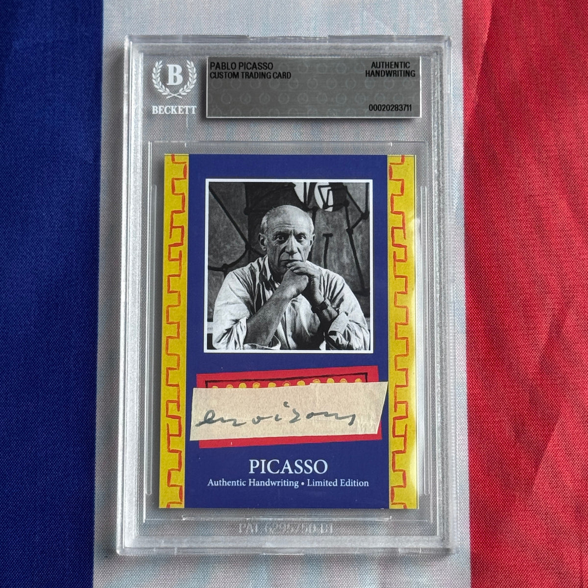 Front view of a Beckett-slabbed blue card with a black-and-white portrait, a cream handwritten signature strip, and printed PICASSO lettering.