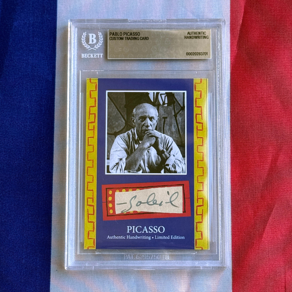 Front view of a graded card in a plastic slab, showing a black-and-white portrait photo and green handwritten signature.