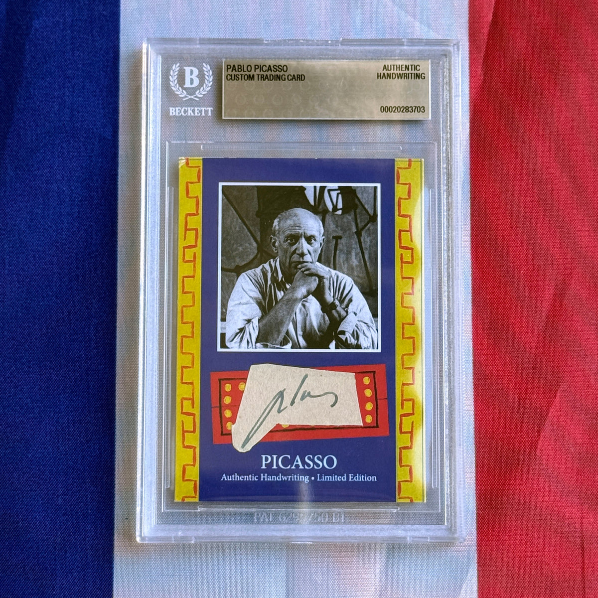 Front view of a Beckett-slabbed card with a black-and-white portrait and pasted signature slip, on a tricolour background.
