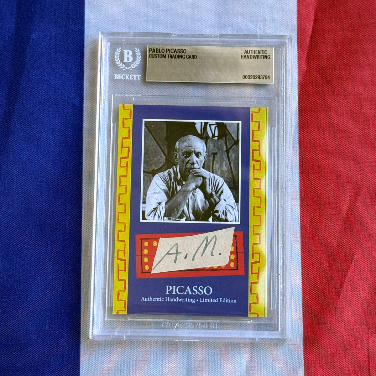 Front view of a Beckett-sealed card with a black-and-white portrait photo, a handwritten "A. M." strip, and "PICASSO" lettering.
